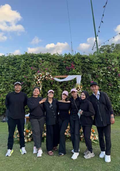 The About Wedding crew together at an outdoor ceremony